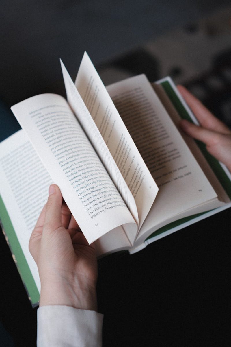 hands flipping pages of an open book