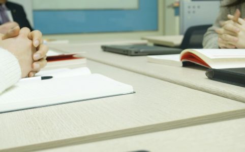 open book with person s hand on top