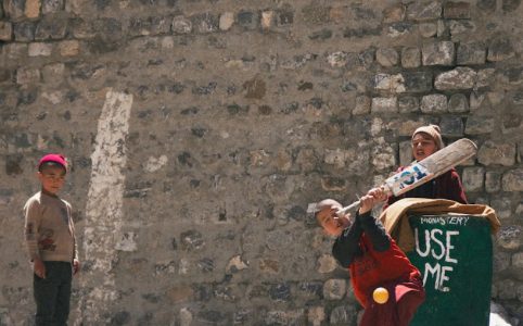 children playing cricket in key village